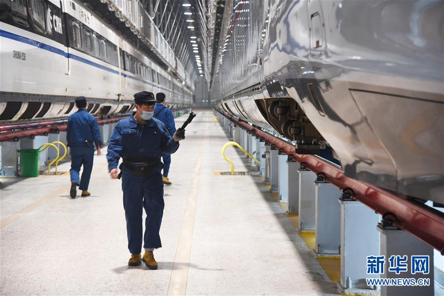 2月12日晚，济南东动车所的检修机械师在对一列复兴号进行检查。新华社记者王凯摄